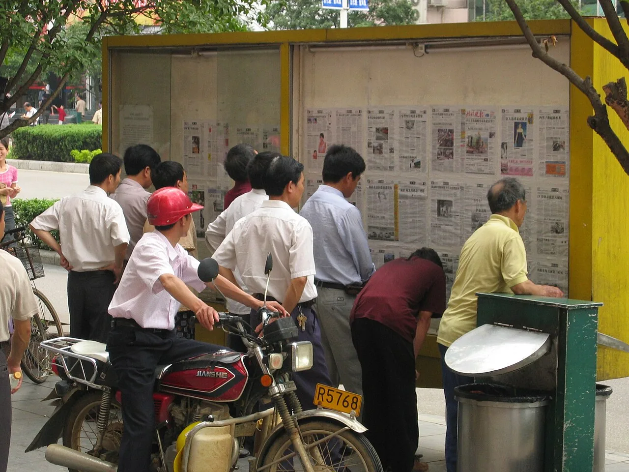 People reading newspaper in Guilin, China 2005-05-15